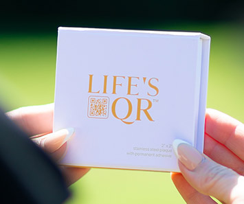 A woman holding a Life's QR Box