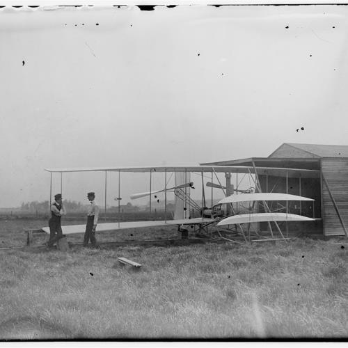 Wilbur and Orville Wright with their second powered machine beside a hanger; Huffman Prairie, Dayton, Ohio Wilbur and Orville Wright with their second powered machine at Huffman Prairie Ohio, May 1904