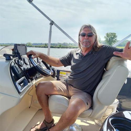 Rick on his pontoon at Muskegon lake