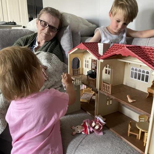 Marilyn watching her great grandkids play (Henry & Ellie)