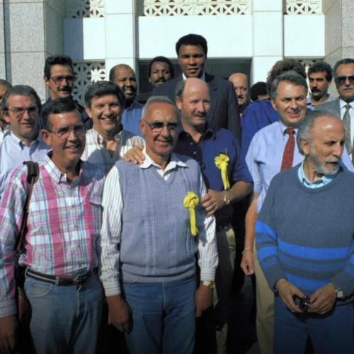 Despite warnings, Ali travels to Baghdad, Iraq to negotiate the release of 15 United States hostages taken during the Kuwait invasion. Ali meets with Saddam Hussein for nearly an hour and successfully secures the hostages’ release.